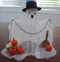 craft a ghost from cheesecloth and dress him in a top hat.
